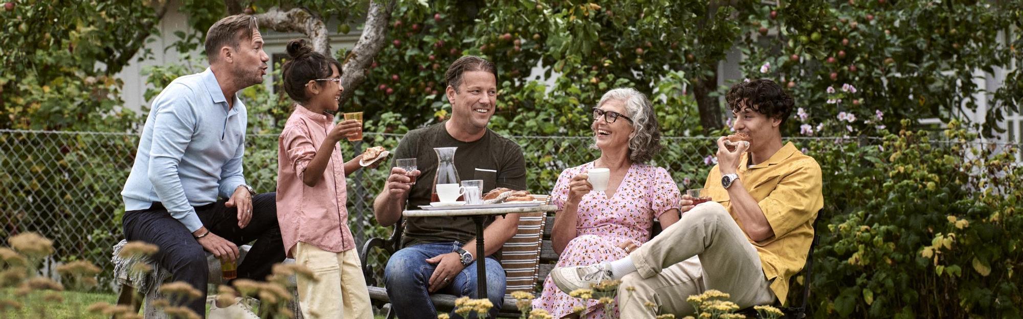 Family and friends having a picnic in the garden