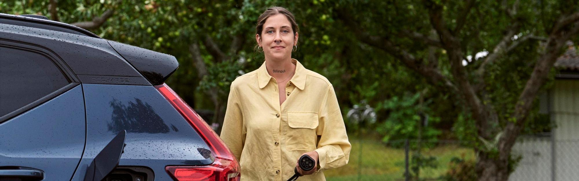 Woman charging electric car