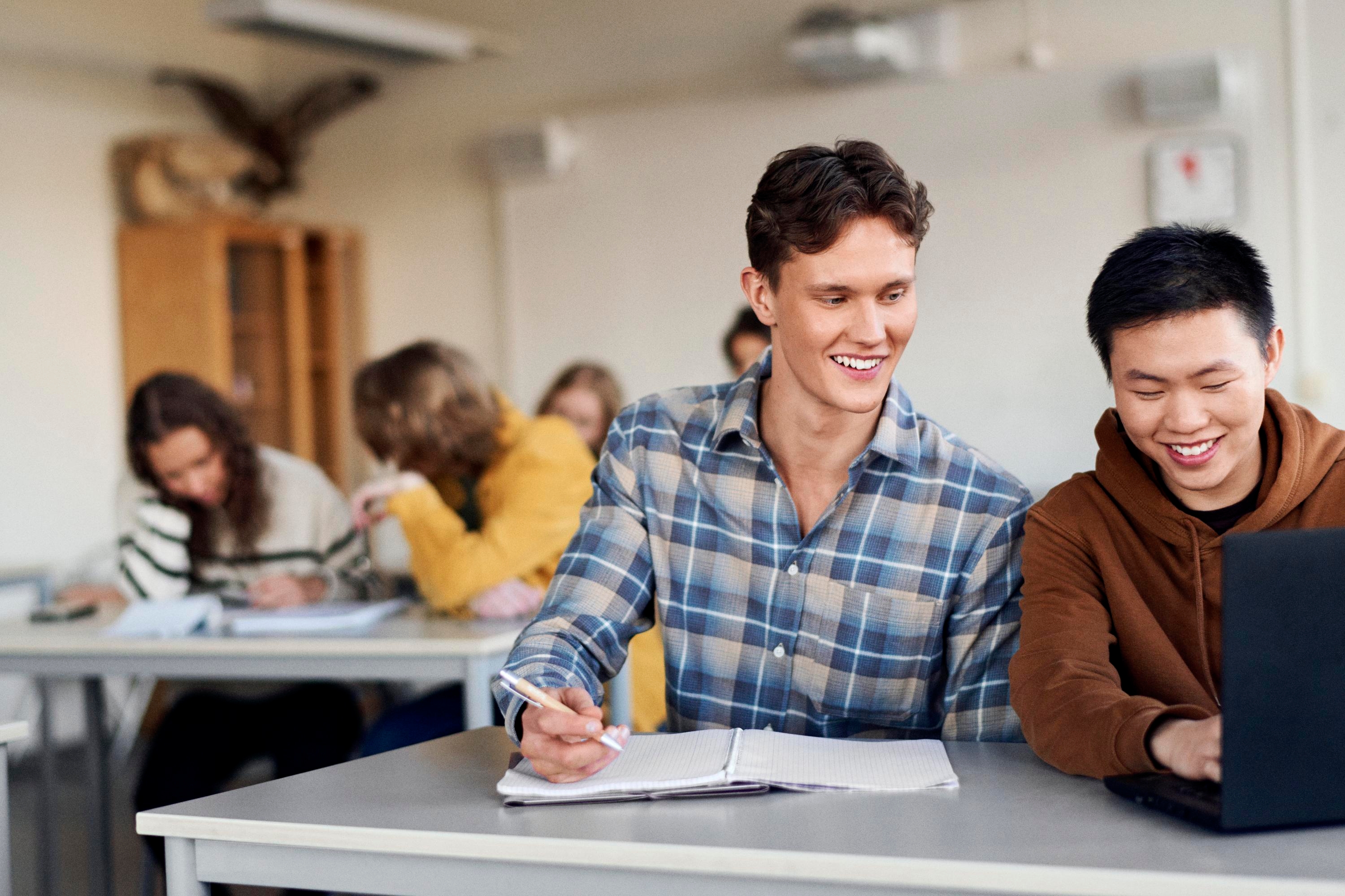 Students studying at a desk in classroom