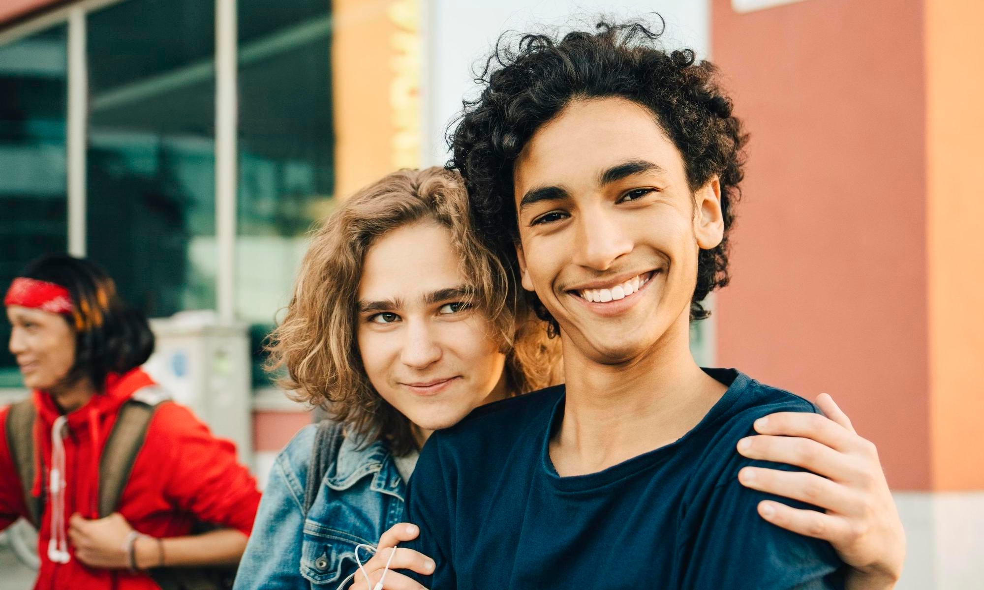 Two young adult friends smiling