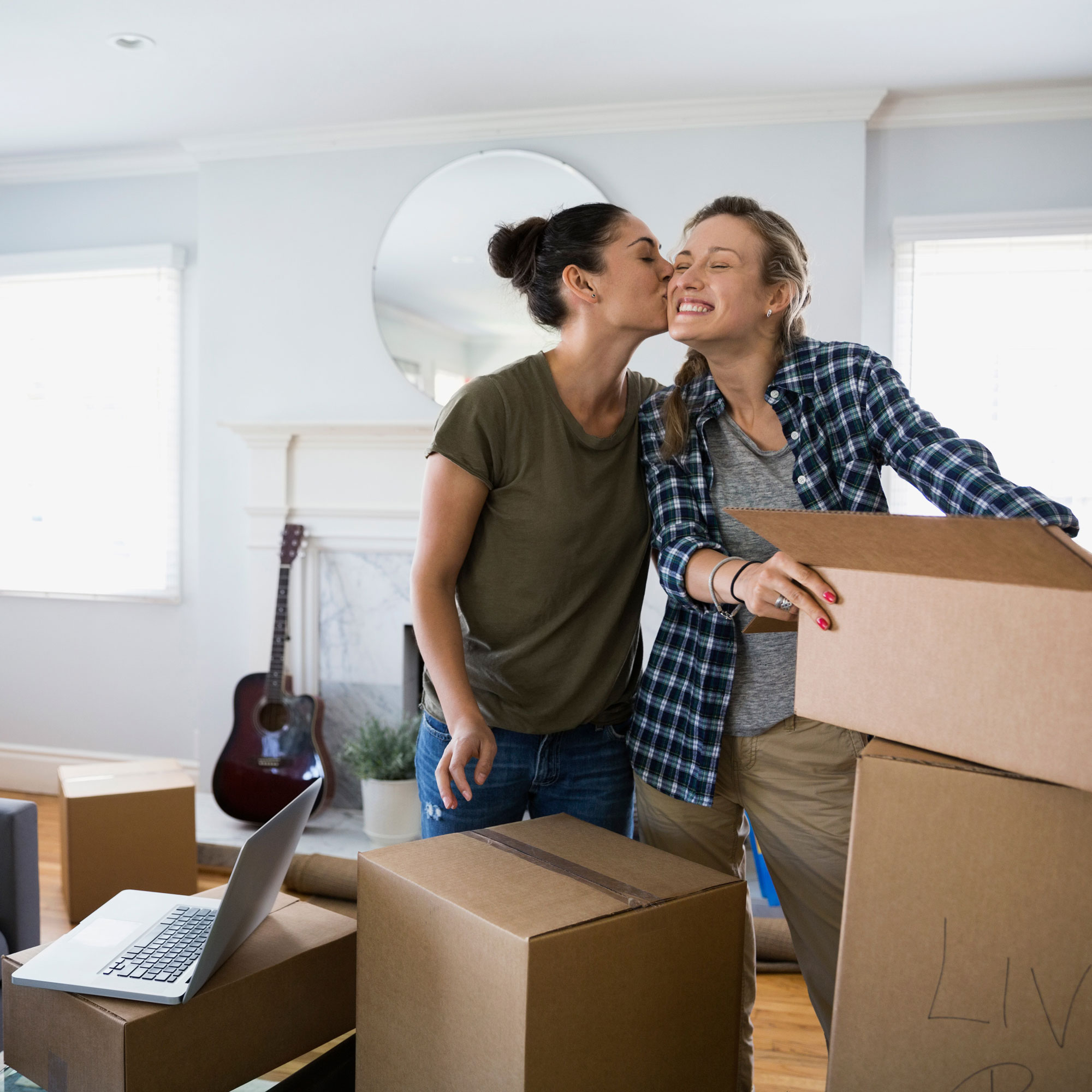 Confident - Dad holding his daughter among moving boxes